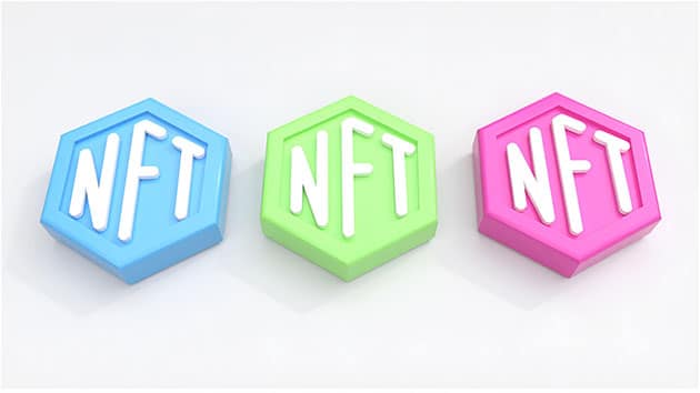 Three geometric shapes in in blue, green and pink with NFT written on them