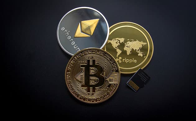 Image of ethereum, bitcoin and ripple cryptocurrency on black background