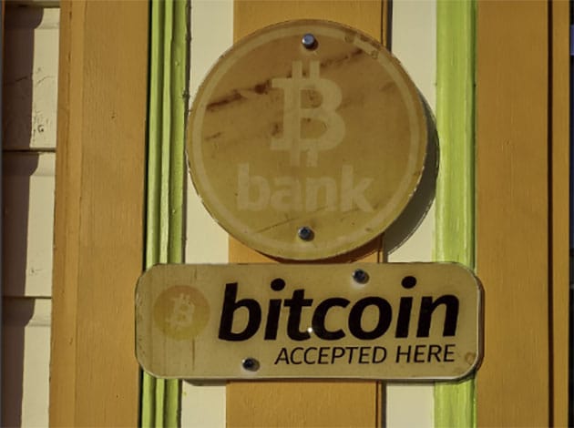 Picture of store with a sign that says “bitcoin accepted here”