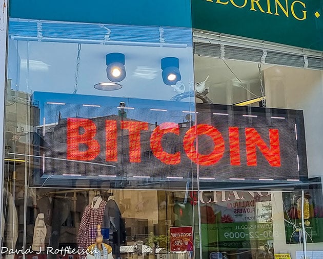 Storefront with signage that reads bitcoin in big red letters