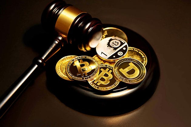 Crypto coins next to a court hammer