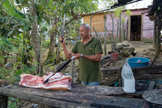 man cutting piece of meat